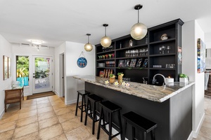 Gather around your private Tiki bar, ideal for cocktails, conversation, and connection.