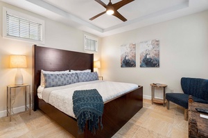 Modern second guest bedroom with sleek furnishings and artistic wall decor.