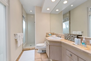 Your private sanctuary features a spacious walk-in shower, elegant vanity, and thoughtful coastal touches that make daily routines feel luxurious.