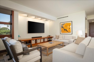 Wall mounted flatscreen television, modern lighting and furnishings.
