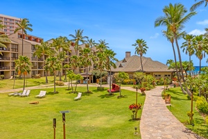 Stroll through tropical grounds at Kaanapali Shores 213, surrounded by trees and greenery.