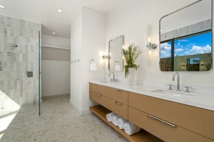 Step into your spa-like sanctuary with dual vanities, quartz countertops, and a luxurious glass shower that makes every morning feel indulgent.