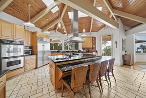 Your gourmet kitchen awaits with granite countertops, professional appliances, and vaulted wood ceilings creating the perfect space for memorable meal preparation.