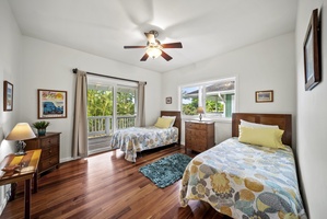 Another view of the bright twin bedroom—airy and inviting, this space ensures everyone enjoys comfort and privacy throughout their stay.
