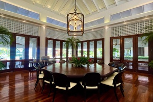 Elegant dining area with a large round table and stunning views of the outdoors.