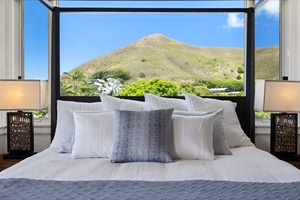 The primary suite featuring a king-sized bed with views.