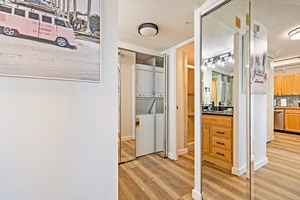 Mahana 718’s hallway includes mirrored closet doors and an in-unit washer and dryer.