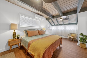 Cozy primary suite with island-inspired decor, warm tones, and a peaceful retreat for relaxation.