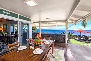 Covered outdoor dining with plenty of space for the whole group to gather by the sea.