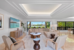 Island comfort meets upscale design in the living room at Honolulu Lagoonfront Villa—with direct access to outdoor serenity.