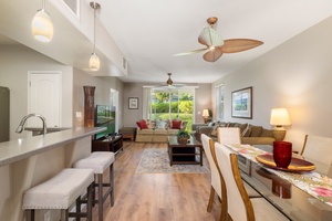 You'll love the open-concept design where tropical ceiling fans keep you cool while you relax on plush seating or prepare meals at the sleek breakfast bar.