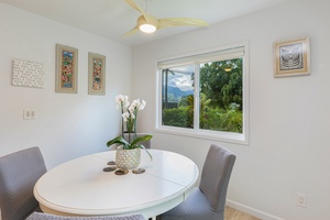 Cozy dining area with seating for four, natural light and peaceful garden views.