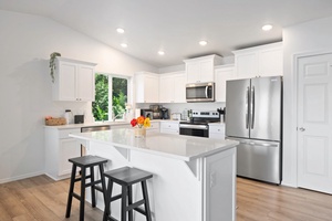 Cook, dine, and connect with ease in this modern kitchen featuring bar seating and high-end appliances—perfect for casual mornings or festive nights in.