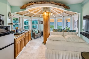 Sleep under your own tropical umbrella canopy while enjoying kitchen convenience and stunning ocean views from this unique beachside retreat.