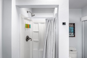 Shared bathroom with walk-in shower and simple island-inspired touches.