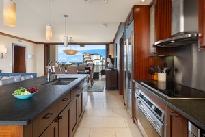 Your gourmet kitchen features premium appliances and sleek countertops, opening to stunning ocean views that make cooking feel like a luxury retreat.