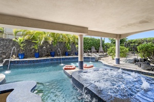 Private pool with shaded lounging and in-pool seating—swim, float, or relax in total comfort.