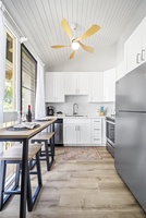 Pull up to the counter for a quick bite, two stools waiting under the cabinets.