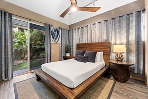 Unwind in your serene bedroom with warm wood accents, tropical garden views, and modern comfort for peaceful sleep.
