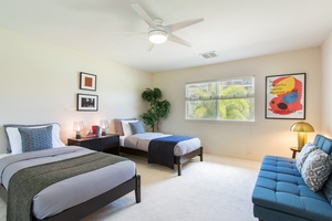 Contemporary second-floor twin bedroom with sofa bed.