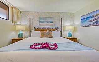 The serene bedroom at Kaanapali Shores 544 offers plush bedding, soft lighting, and coastal décor.