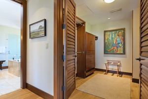 Step into your tropical retreat where warm wood accents and thoughtful artwork create an inviting entrance to your private sanctuary.