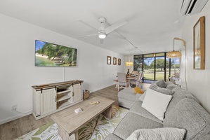 Downstairs living room with queen sleeper sofa, sitting area and outdoor screened lanai.