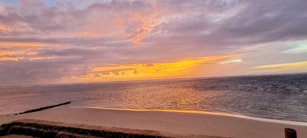 Sunset over the water, the sky doing its slow color change past the point.