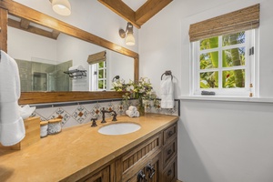 The ensuite bathroom with single vanity and walk-in shower.