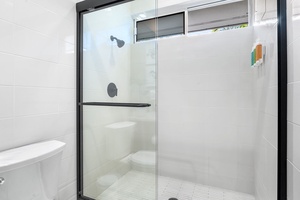 Step into your spacious glass shower with modern fixtures and sleek design for a refreshing start to your day.