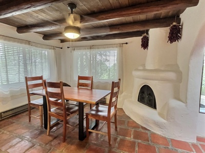 Dining area set against kiva fireplace