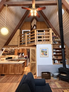 Spacious A-Frame living, dining, kitchen areas with three bedrooms above.
