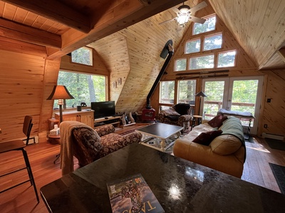 A Frame Living Room with tv and wood stove