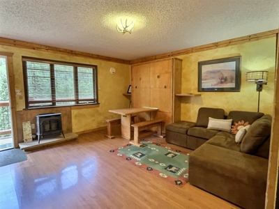 Living Area with Murphy Bed up and Dining Table in Place and Gas Fireplace