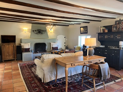 Formal living area with work desk and massive adobe fireplace