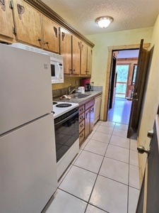 Galley Kitchen with View through Front Room to Deck