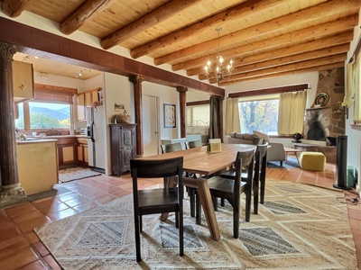 Dining area and kitchen and second living area with wood stove