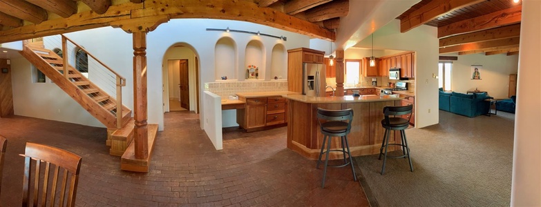 A glimpse of the kitchen with island and bar seating and spacious countertop