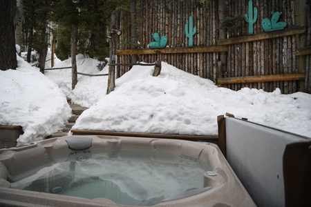 Private hot tub surrounded by snow