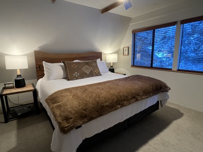Beautiful top floor king bedroom with luxury bed and bedding and mountain views