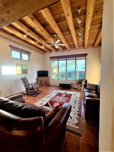 Living room with tall windows and ceiling fan