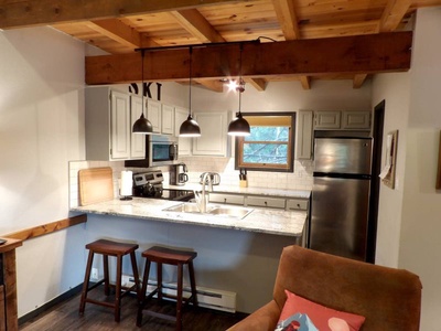 Kitchen with island and barstool seating