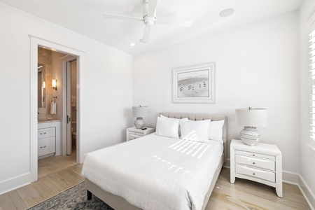 Rest peacefully in your serene bedroom, where crisp white linens and gentle coastal artwork create the perfect sanctuary for sweet dreams.