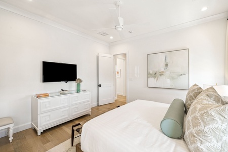 Unwind in your serene bedroom featuring crisp linens, modern amenities, and soothing coastal decor for the perfect restful retreat.