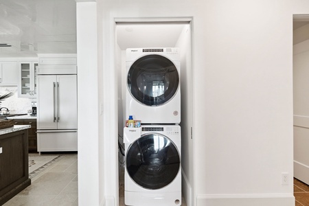 Your laundry needs are handled with these conveniently placed washer and dryer units, tucked neatly into this bright, modern space.