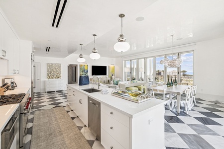 Your gourmet kitchen flows seamlessly into the bright dining space, where stunning city views complement your culinary adventures.