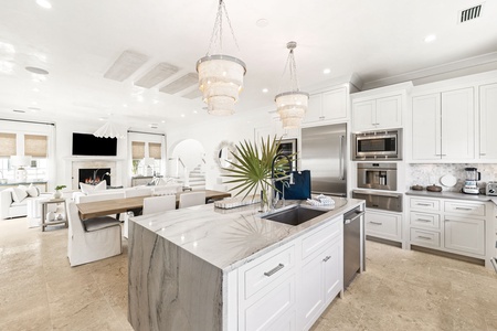 Your gourmet kitchen sparkles with marble countertops, crystal chandeliers, and top-tier appliances—perfect for creating culinary memories in elegant style.