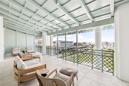 Relax on your private terrace with elegant outdoor seating and sweeping city views through decorative railings.