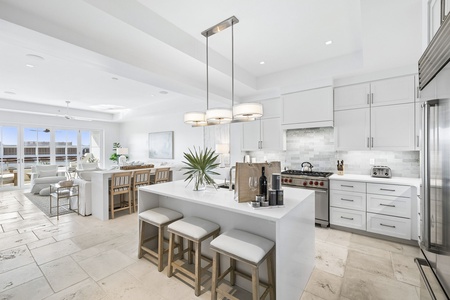 Your open-concept kitchen and living space combines sleek modern design with coastal warmth, where you'll cook on professional-grade appliances and gather around the bright island or dine by the view.