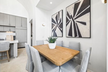 Gather around this inviting dining space where the natural warmth of the wood table creates the perfect setting for your vacation meals and conversations.